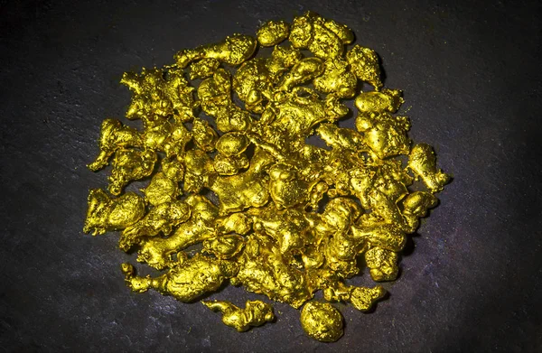 Real golden nuggets isolated on black background. — Stock Photo, Image