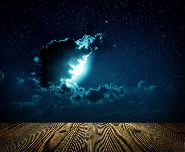 Backgrounds night sky with stars, moon and clouds. wood floor