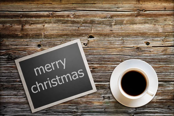 Photo with the text merry christmas lies on a wooden table with — Stock Photo, Image