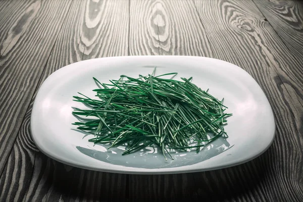 Fresh green salad with wheat seedling, on a plate on a old vinta — Stock Photo, Image