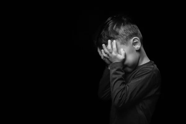 Child whose depression is on a black background — 스톡 사진