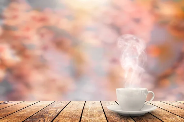 hot coffee on the table on a spring background