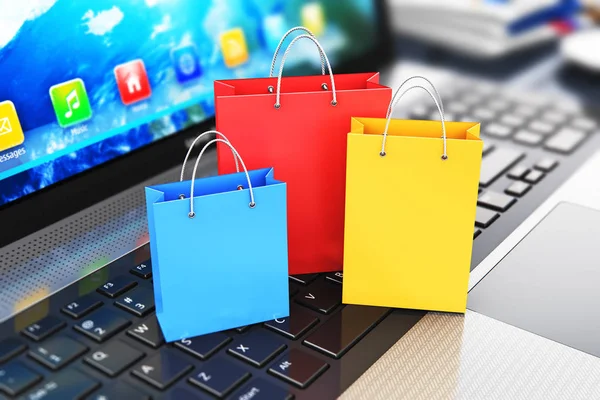 Grupo de bolsas de compras de papel de color en el teclado portátil —  Fotos de Stock