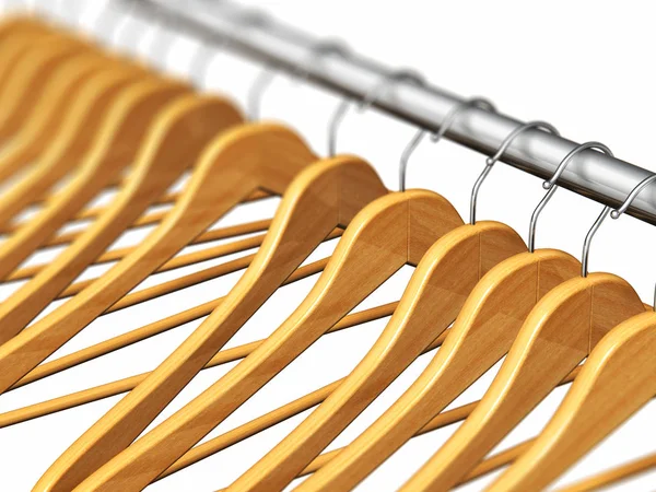 Wooden coat hangers on clothes rail — Stock Photo, Image