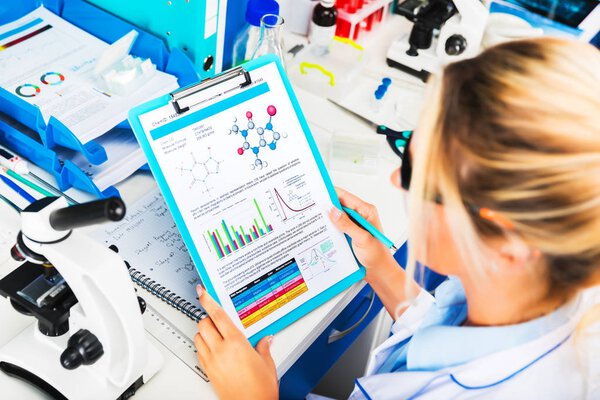 Young attractive woman scientist researching in the laboratory