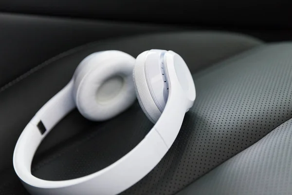 Wireless headphones on the car seat — Stock Photo, Image