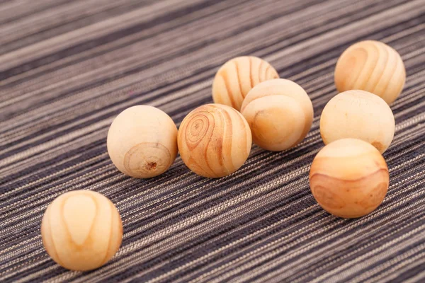 Wooden balls on fabric background — Stock Photo, Image