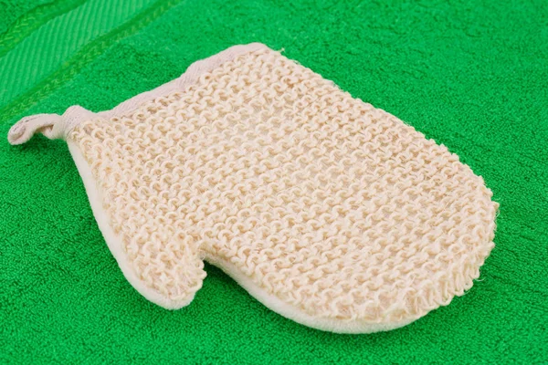 Glove massager on towel — Stock Photo, Image