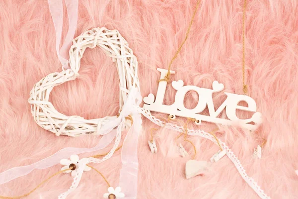 White wooden heart and word love