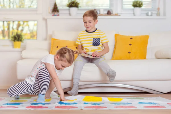 Two happy children playing exciting game at home — Stock Photo, Image