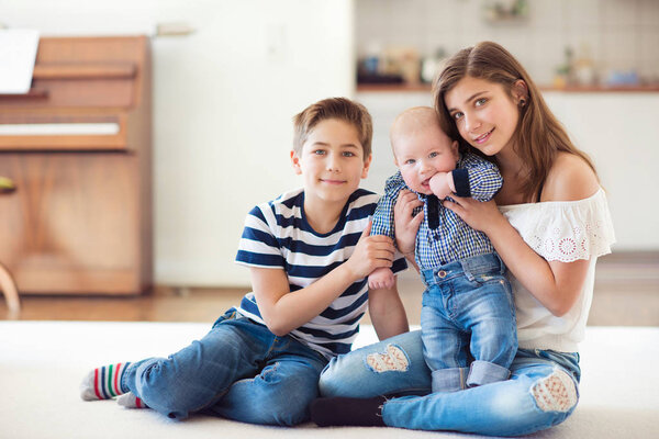 Smiling family of three children