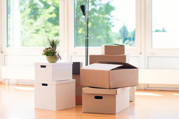 Many cardboard boxes in bright house during relocation — Stock Photo, Image