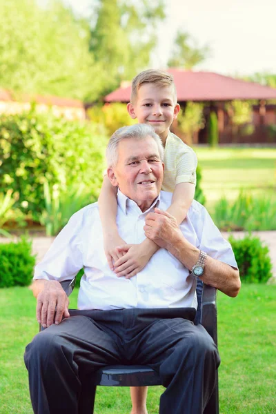 Portrait of happy old grandfather and cute children — Stock Photo, Image