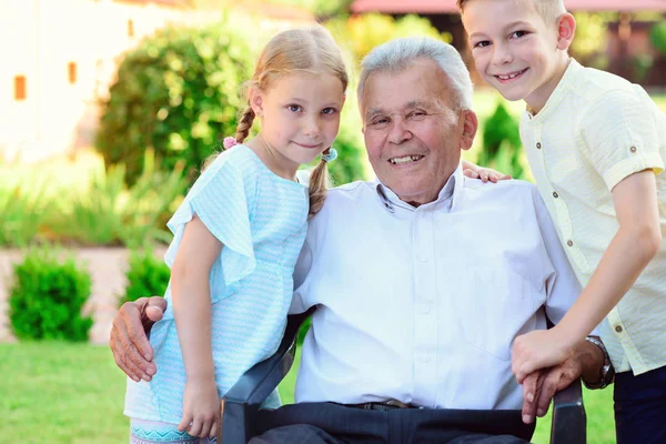 Portrait of happy old grandfather and cute children — Stock Photo, Image