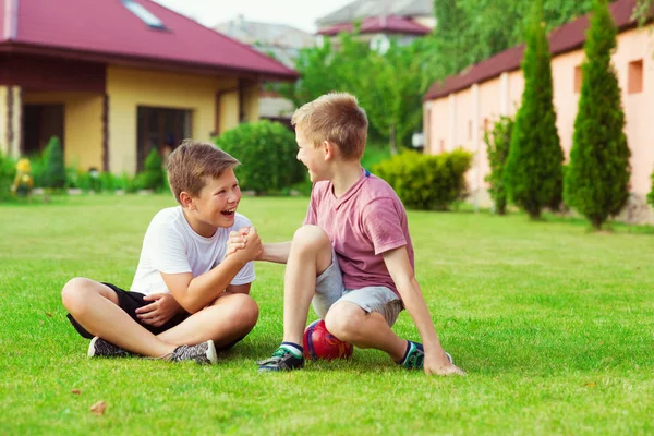 Twee jongens plezier tijdens het voetballen in schoolplein — Stockfoto