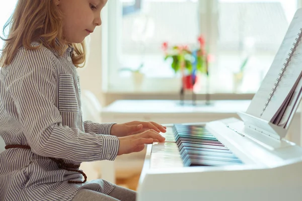 Cute little girl has training with piano — Stock Photo, Image
