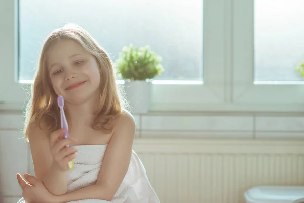 Portrait of pretty little child girl with white towel after show — Stock Photo, Image