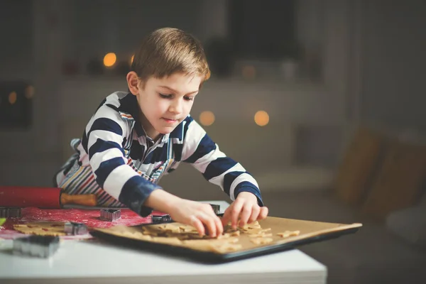 Happy little child preparing cookies for Christmas and New Year — Stock Photo, Image