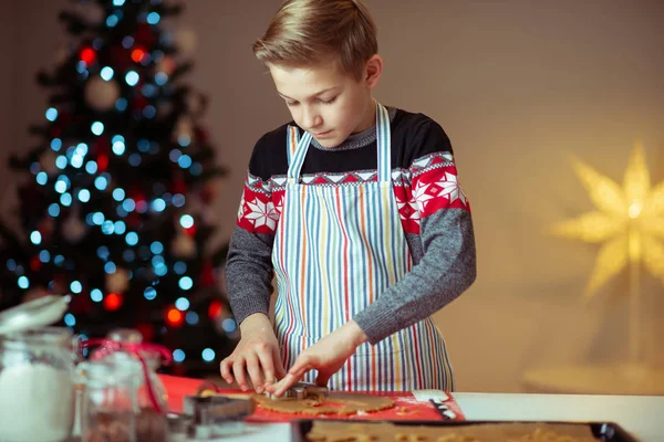 Portré tini fiú csinál gyömbéres sütik karácsony este szellemes — Stock Fotó