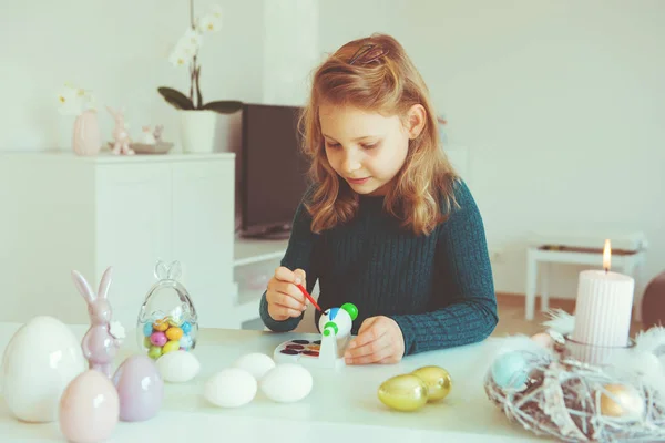Linda niña rubia pintando huevos de Pascua — Foto de Stock