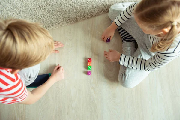 İki zeki çocuk renkli zarlarla oynayan matematik okuyor. — Stok fotoğraf