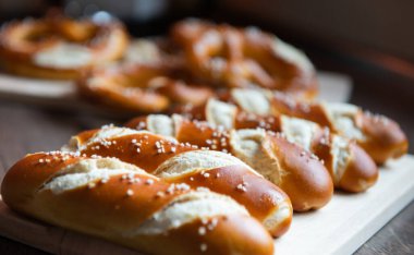Closeup photo of lye roll bun and bavarian pretzel in bakery clipart