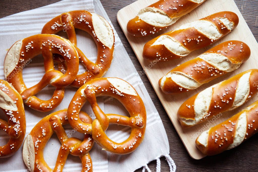 Closeup photo of lye roll bun and bavarian pretzel in bakery