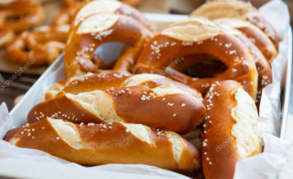 Closeup photo of handmade lye bun and bavarian pretzel in bakery