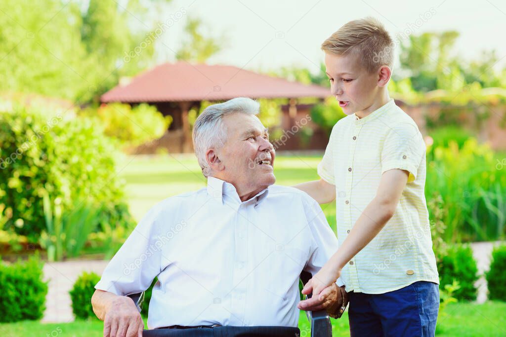 Teen grandson visiting his old grandfather at nurising home 