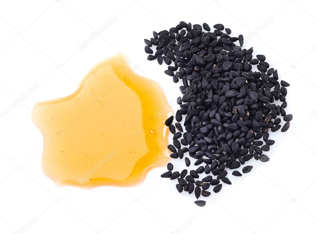 Black cumin oil with seeds in closeup