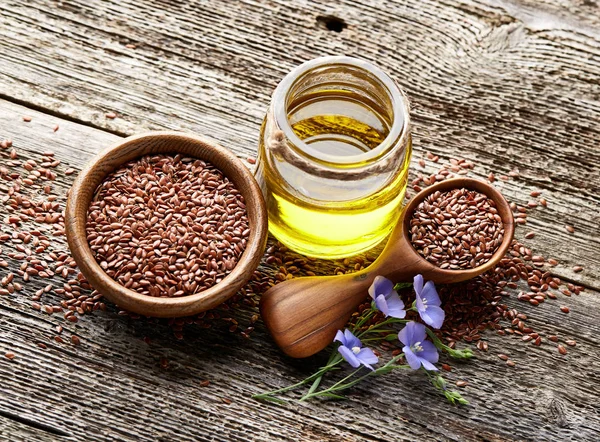 Flax oil on wooden board — Stock Photo, Image