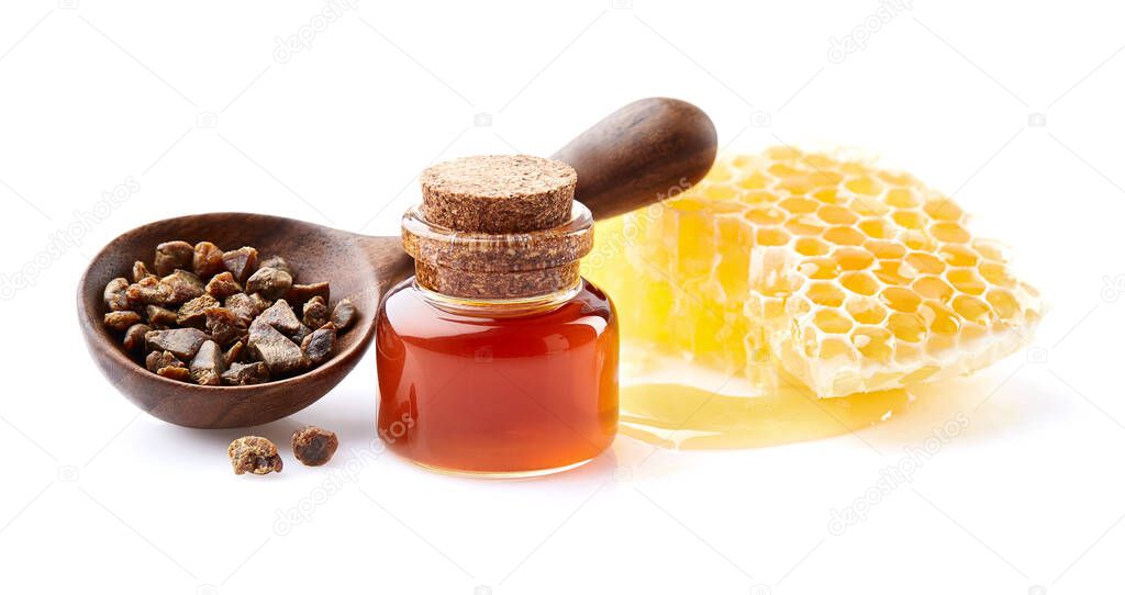 Propolis granule with honeycomb and  propolis tincture on white background