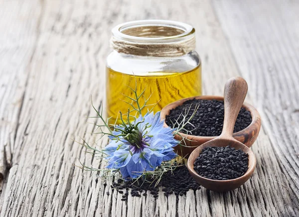 Aceite Comino Negro Con Flor Nigella Sativa Sobre Mesa Madera — Foto de Stock