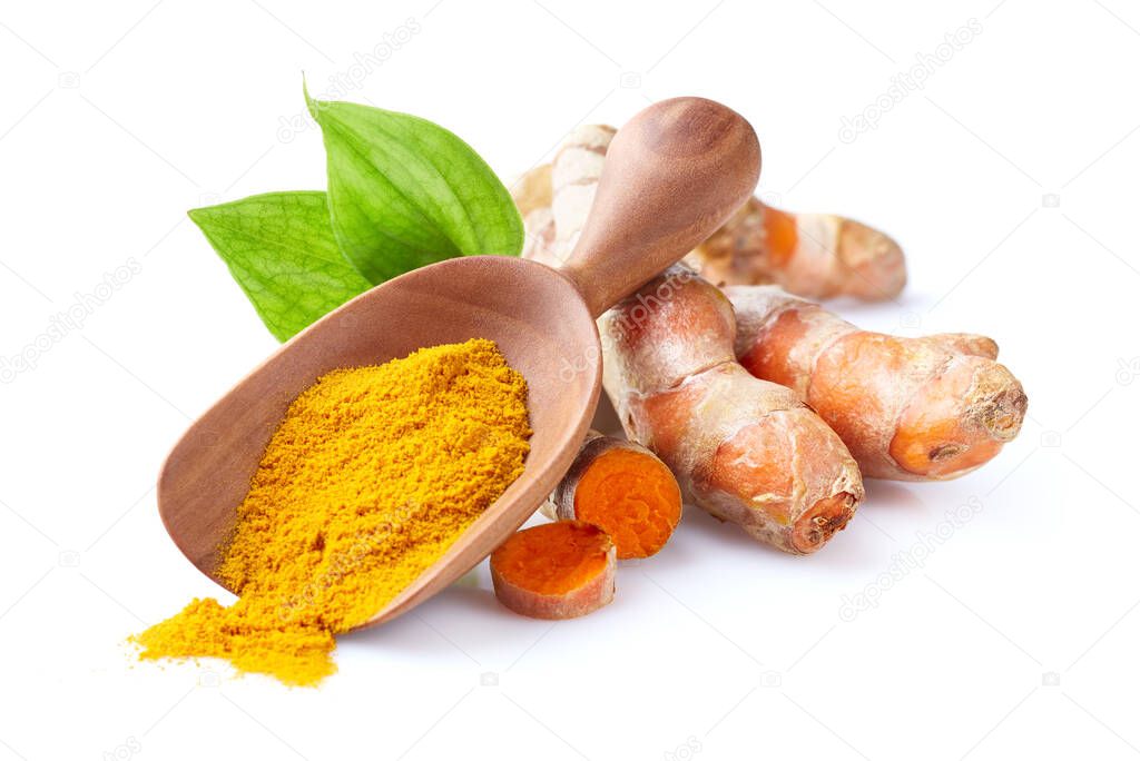Turmeric powder and root with leaves on white