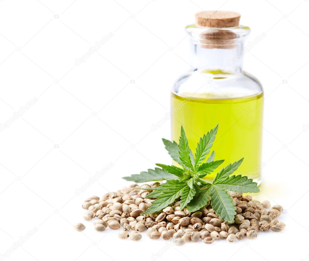 Hemp oil with hempseeds on white background