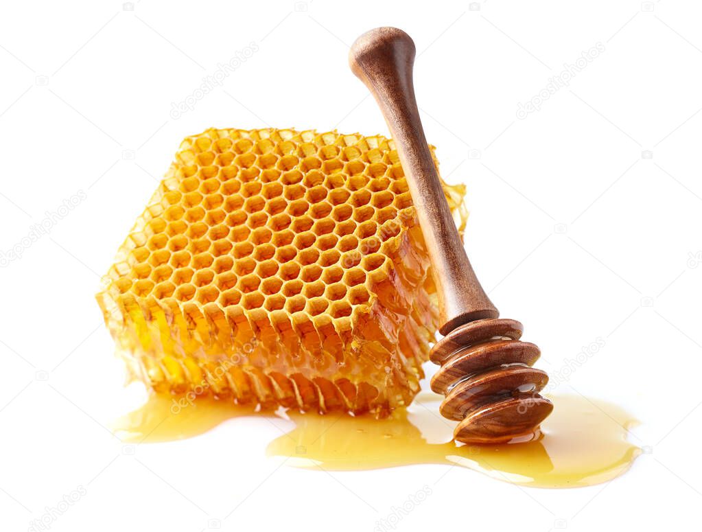 Honeycomb with spoon on white background