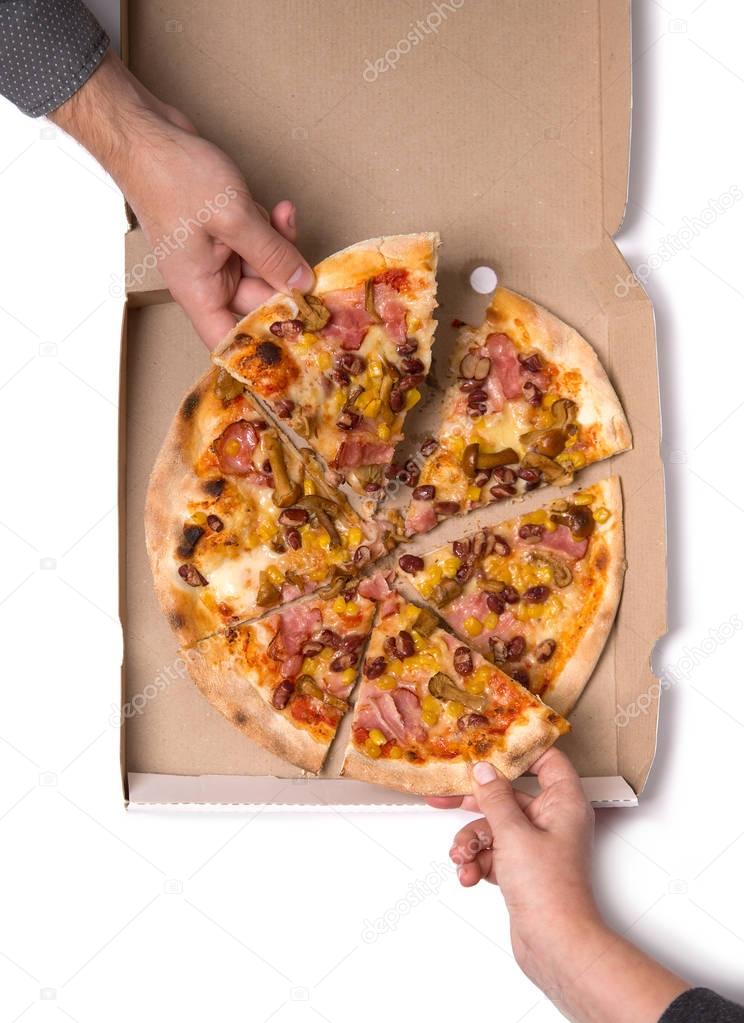Young couple taking pizza slices 