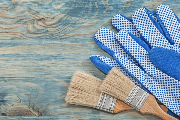 Paintbrushes and protective gloves — Stock Photo, Image