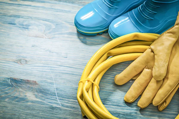 Waterproof boots with leather protective gloves — Stock Photo, Image