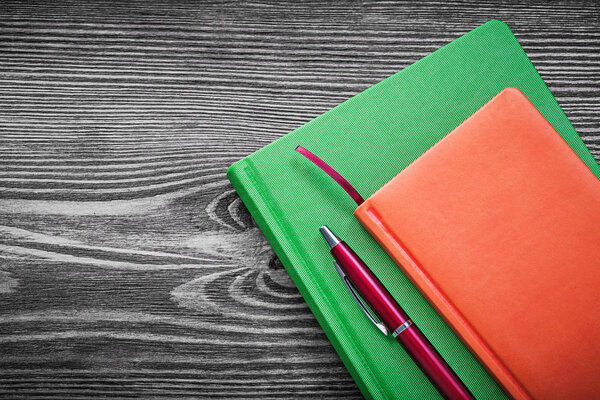 Diary books pen on vintage wood board office concept