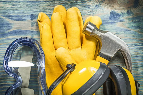 Safety glasses leather gloves claw hammer on wooden board constr — Stock Photo, Image