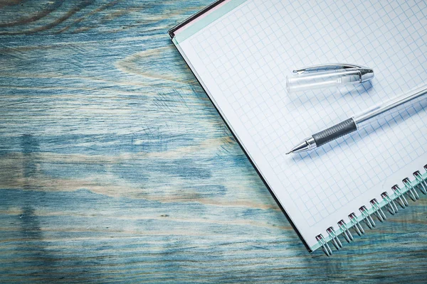 Squared copybook pen on wooden board office concept — Stock Photo, Image