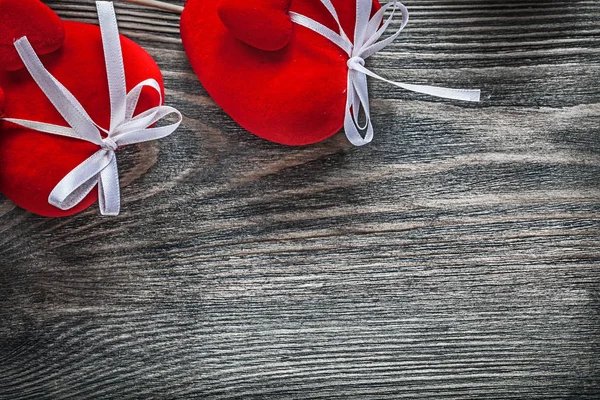 Composition of red fabric hearts on wooden board celebrations co — Stock Photo, Image