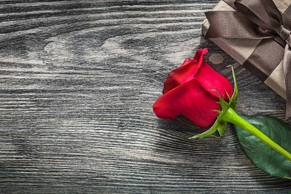 Red rose gift box on wooden board holidays concept