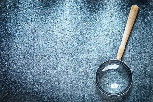 Vintage magnifier with wooden handle on black surface — Stock Photo, Image