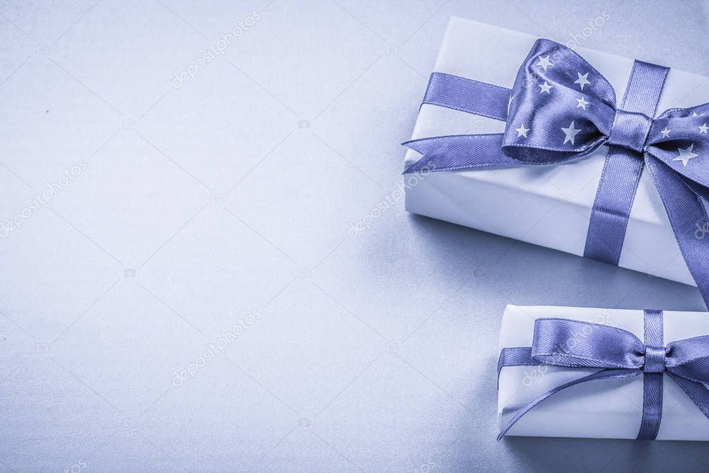 Two gift boxes on blue background horizontal image holidays conc
