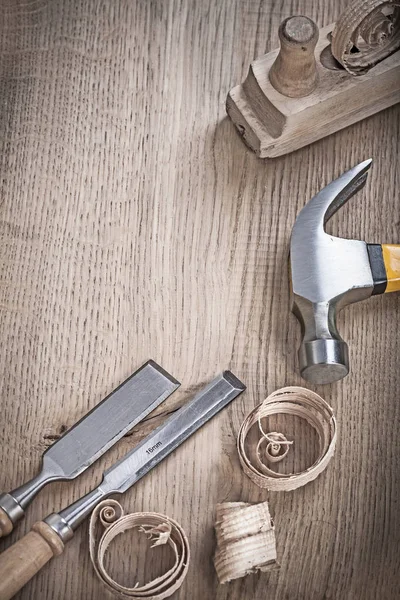 Close up view on hammer chisels and planner shavings — Stock Photo, Image