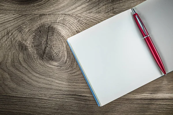 Opened blank notebook ballpoint pen on wooden board — Stock Photo, Image