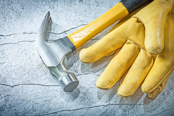 Leather protective gloves claw hammer on metallic background con — Stock Photo, Image