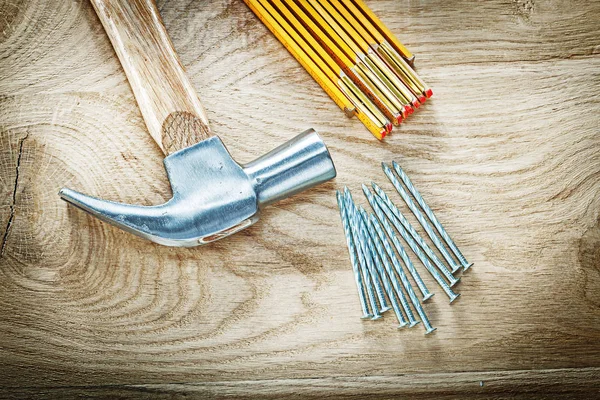 Composition of claw hammer wooden meter construction nails on wo — Stock Photo, Image